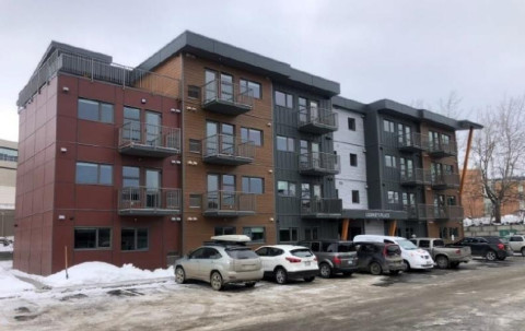 Four-storey apartment building surrounded by snow, located at 1260 Hillside Court in Kamloops.