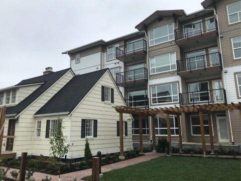 Heritage house sits in front of a four-storey apartment building, located at 22325 Saint Anne Avenue in Maple Ridge.