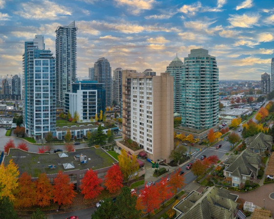 Series of tall buildings in Burnaby, including 1850 Rosser Avenue, with a dramatic sunset in the background.