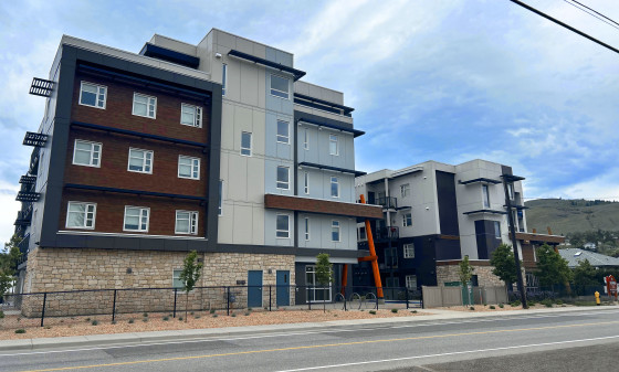 Five-storey building with varied siding colours and architectural styles.