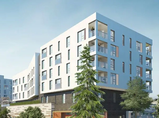A modern mid-rise apartment building rendering on a sunny street corner with trees, cars, and a few pedestrians.