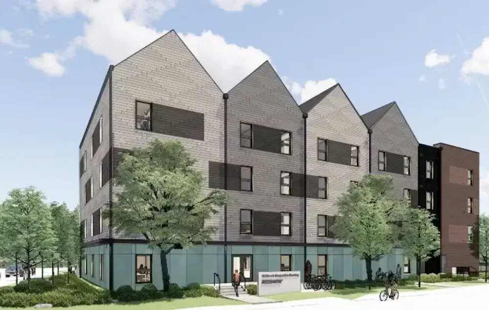 A drawing of a 3-4 storey apartment building. With a peaked roof line, blue sky and trees in front.