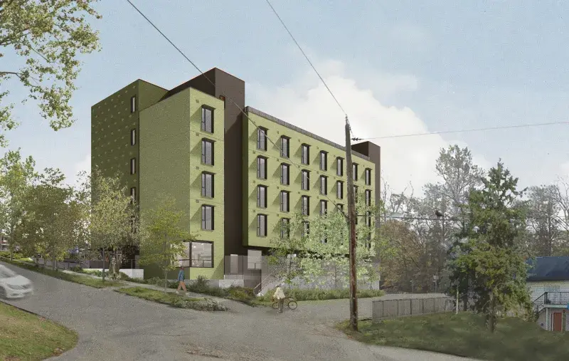 Green low rise building set on a slope