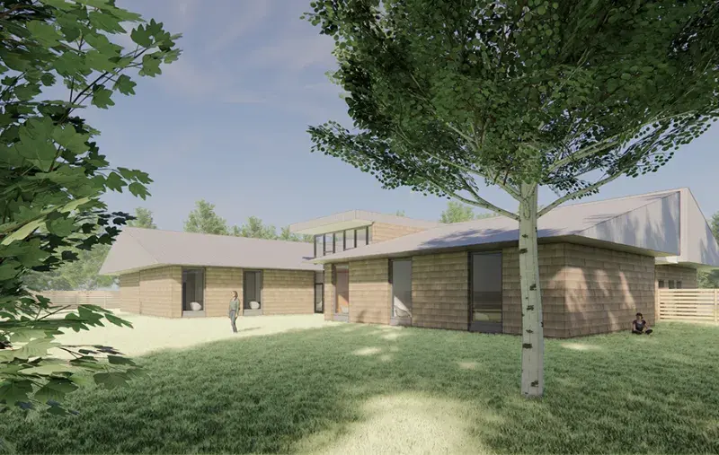 Artist rendering of low-rise complex care housing with wood-clad buildings, grassy courtyard, trees, and people outdoors.